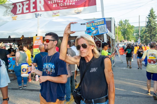 Festivalgoers enjoy food, music, and the atmosphere as they gather ahead of the evening's headlining performance during Musikfest on Saturday, Aug. 8, 2026, in Bethlehem. The annual festival runs through Aug. 9. (Jonathan Broady/Special to The Morning Call)