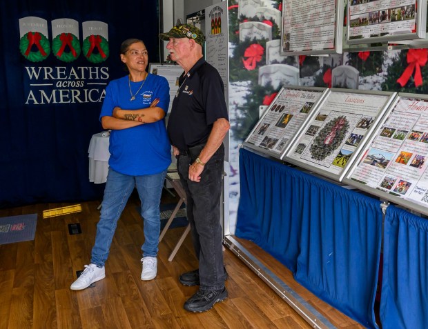 Army veteran Patrice Cook, who drives one of the tractor-trailers transporting Wreaths Across America's Mobile Education Exhibit, talks with Marlin Bozes of Allentown on Thursday, Aug. 27, 2026, at the exhibit at Mission BBQ in Whitehall Township. During August and Early September, the Mobile Education Exhibit is traveling around the state to honor service members and educate the local community. It will be at Mission BBQ again 11 a.m. to 54 p.m. Aug. 28; at Nam Knights Vet Fest in Northampton 10 a.m. to 5 p.m. Aug. 29; St. Luke's-West End in Allentown 9 a.m. to 4 p.m. Aug. 31, and at Miller-Keystone Blood Center in Bethlehem noon to 6 p.m. Sept. 1. (April Gamiz/The Morning Call)
