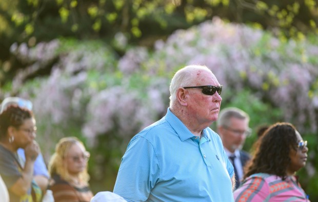While a bell is rung, former Lehigh County District Attorney Jim Martin and others stand silently for the traditional bell ceremony to honor and remember each life taken as a result of violent crime Wednesday, April 23, 2025, during the Crime Victims Council of the Lehigh Valley's annual Victim's Rights Vigil at Tree of Life Memorial Grove in Allentown. (April Gamiz/The Morning Call)