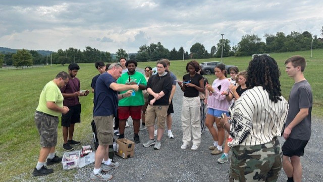 Engineering Ahead students work with Dr. Cesar Martinez-Garza, Associate Professor of Mathematics at Penn State Berks and a mentor from Boeing to launch rockets they designed and built after learning about aerospace engineering.
