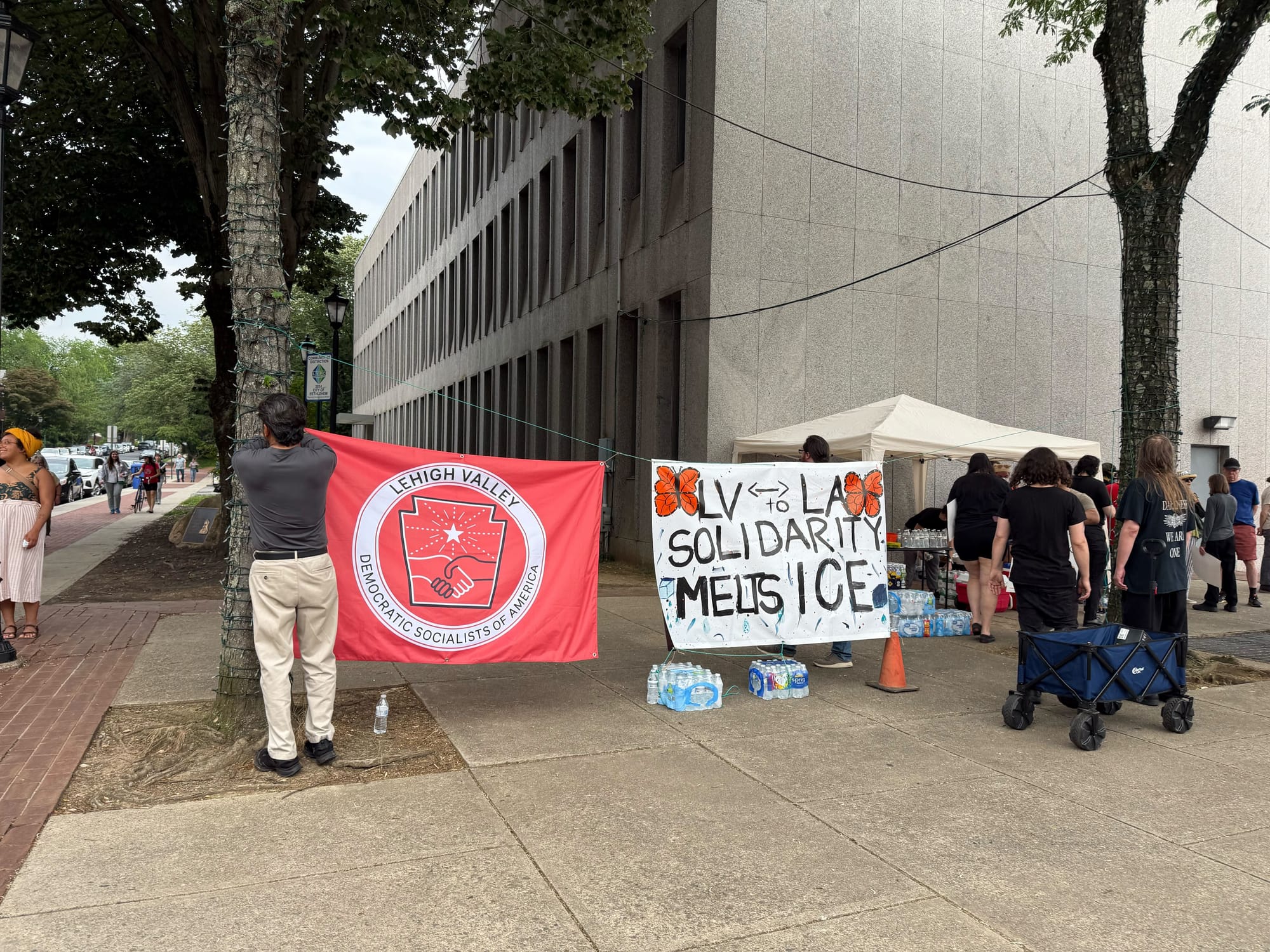 Signs near Bethlehem City Hall at a rally on Thursday, June 12 to protest a federal immigration raid at the fire-damaged Five