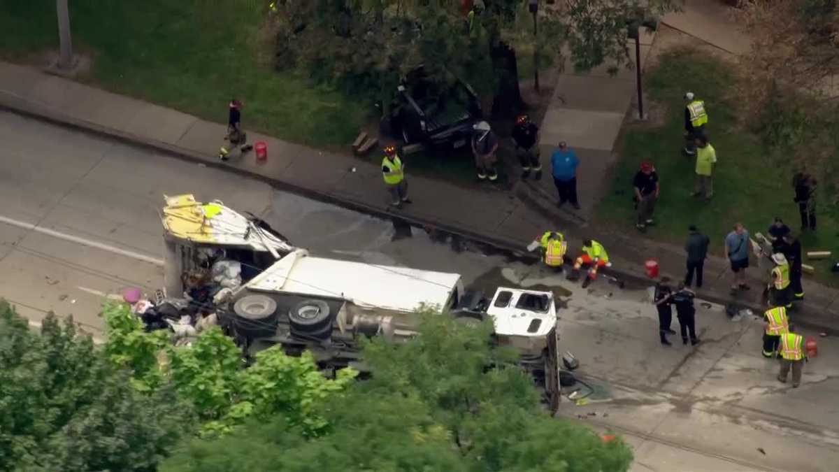 1 hospitalized after garbage truck overturns in multi-vehicle crash