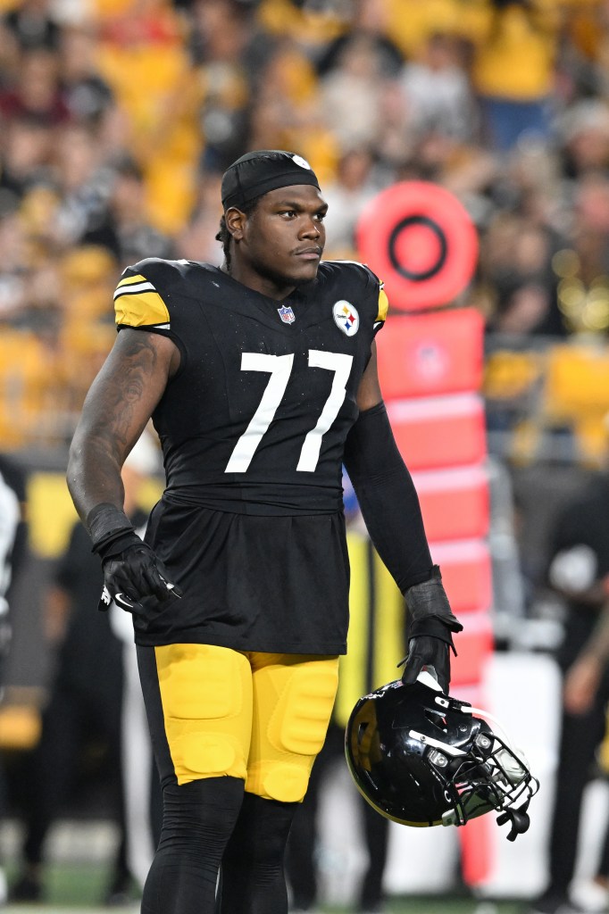 Pittsburgh Steelers offensive tackle Broderick Jones (77) holding his helmet during a game against the New York Jets.