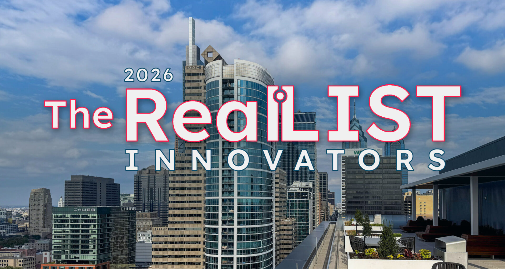City skyline with modern high-rise buildings under a partly cloudy sky; text over image reads “2026 The RealLIST Innovators.” Rooftop terrace with empty tables and chairs in the foreground.