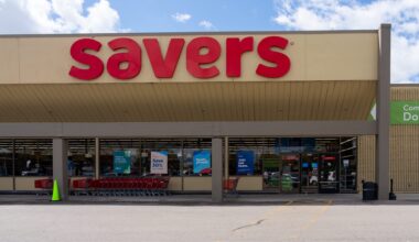 A storefront of a thrift store with red signage and shopping carts outside.