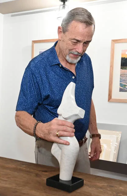 <p>Sculptor David Green places one of his pieces on display for a showing at Art e Fekts Gallery, Downtown Pittston, on Friday. He and painter Frank Wengen held a joint exhibit at Art e Fekts.</p>
<p>Tony Callaio | For Sunday Dispatch</p>