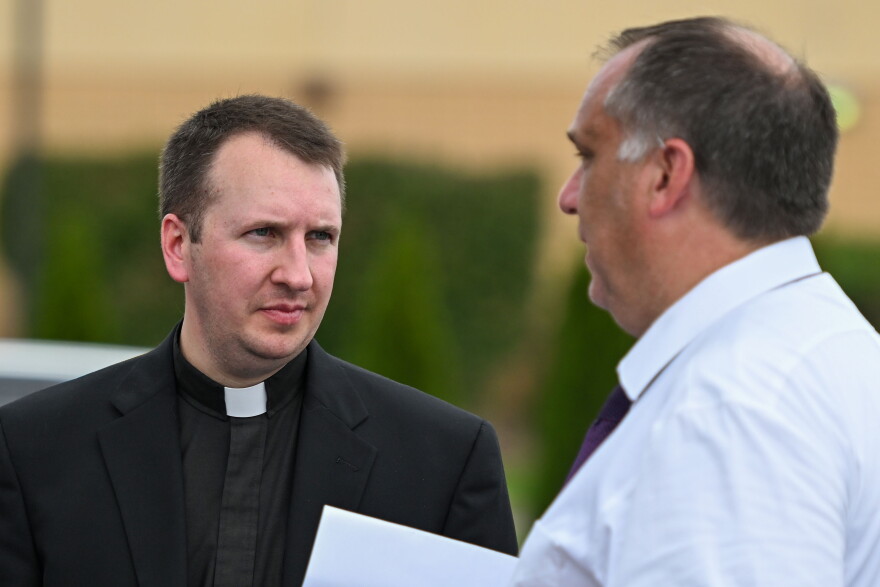 Rev. Michael Drevitch, pastor of St. Maria Goretti Parish in Laflin, Luzzerne County, talks with Diocese of Scranton secretary of communications Eric Deabill after a fire at the Wyoming Area Catholic School on Tuesday, Sept. 1, 2026.