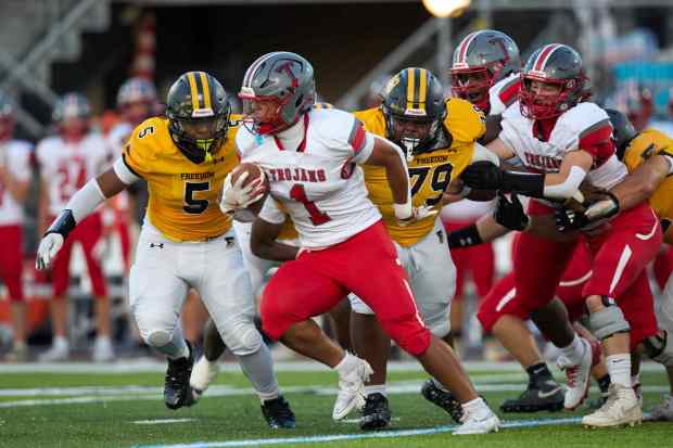 Parkland's T.J. Lawrence is tackled by Freedom's Jahaire Hughes on Friday, Sept. 4, 2026, at Bethlehem School District Stadium. (David Garrett/Special to The Morning Call)