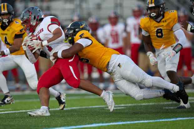 Parkland's T.J. Lawrence is tackled by Freedom's Jahaire Hughes on Friday, Sept. 4, 2026, at Bethlehem School District Stadium. (David Garrett/Special to The Morning Call)
