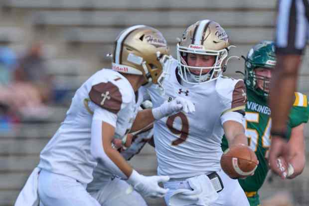 Bethlehem Catholic's quarterback Axel Burkart  hands off to Antonio Salomoni on Saturday, Sept. 5, 2026, at J. Birney Crum Stadium. (David Garrett/Special to The Morning Call)