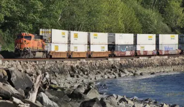 BNSF double-stack container train beside the shoreline at Richmond Beach, Washington