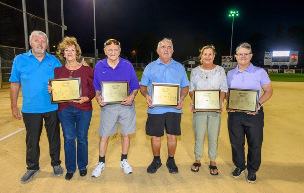 Parents Gary and Joann Warmkessel stand for their late daughter Nicky Warmkessel, Lou Frey, Mike Dartouzos, Judy Lawes, and Jean Buskirk are inducted into the Lehigh Valley Softball Hall of Fame during its 25th annual induction ceremony Wednesday, Sept. 9, 2026, at Patriots Park in Allentown.(April Gamiz/The Morning Call)