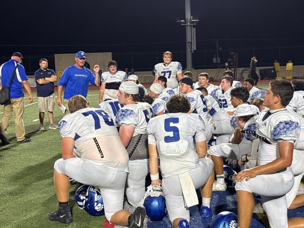 Pleasant Valley football coach Blaec Saeger talks to his players on the field at J. Birney Crum Stadium in Allentown on Thursday night following a 51-6 win over Dieruff. (Keith Groller)