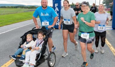 A group of runners crossing the finish line at the