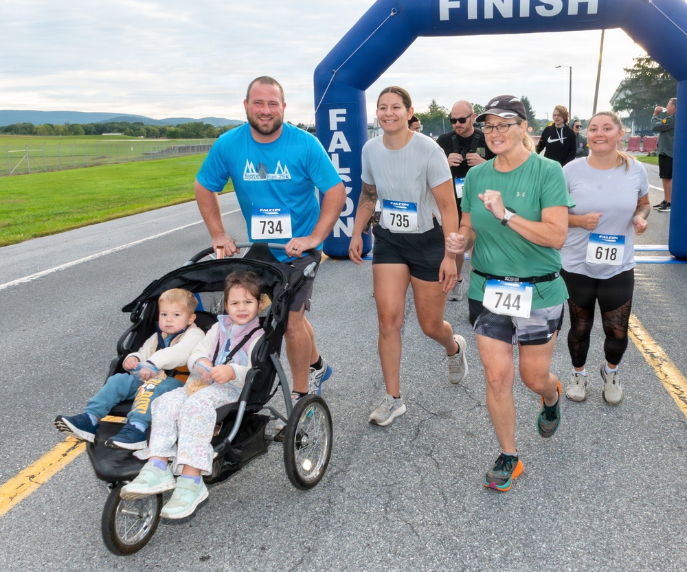 A group of runners crossing the finish line at the
