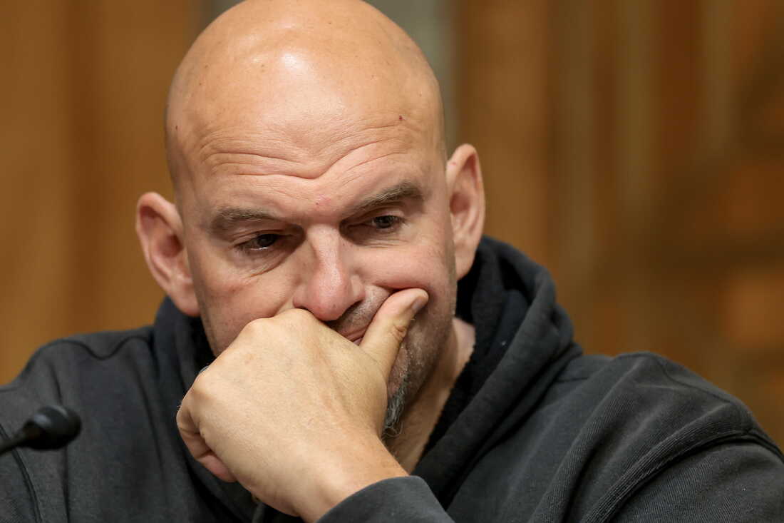 Sen. John Fetterman (D-PA) looks on during a business meeting with the Senate Homeland Security And Government Affairs Committee in the Dirksen Senate Office Building on August 06, 2026. Fetterman's constituents in Pennsylvania told NPR they feel "betrayed" over what they call his antagonistic stance towards the Democratic party.