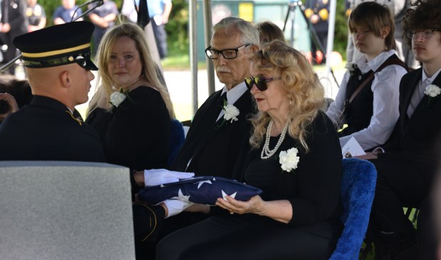 Joan Vannatta is handed the flag at the funeral of her uncle, U.S. Army Private First Class Howard G. Krapf, on Monday, Sept. 21, 2026, at Fairview Cemetery in Whitehall. Krapf was killed in action during World War II but his remains were unidentified for 82 years. (Monica Cabrera/The Morning Call)