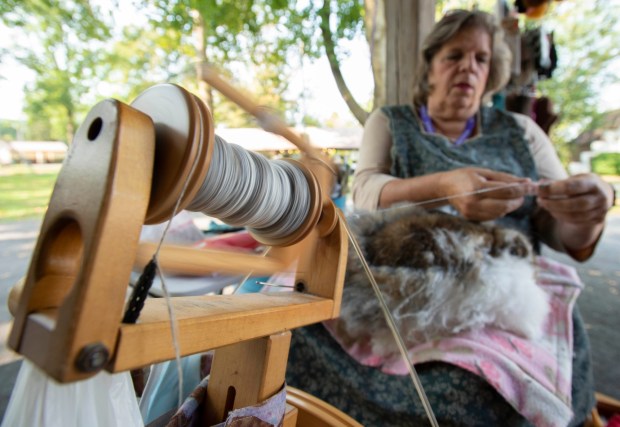 Emily Gargiulo of High Point Homestead takes the fur and spins it into yarn Sunday during the Lehigh Valley Fiber Festival at Macungie Memorial Park. This year's festival had more than 45 artists on hand showing off their products to celebrate all things fiber to fabric.