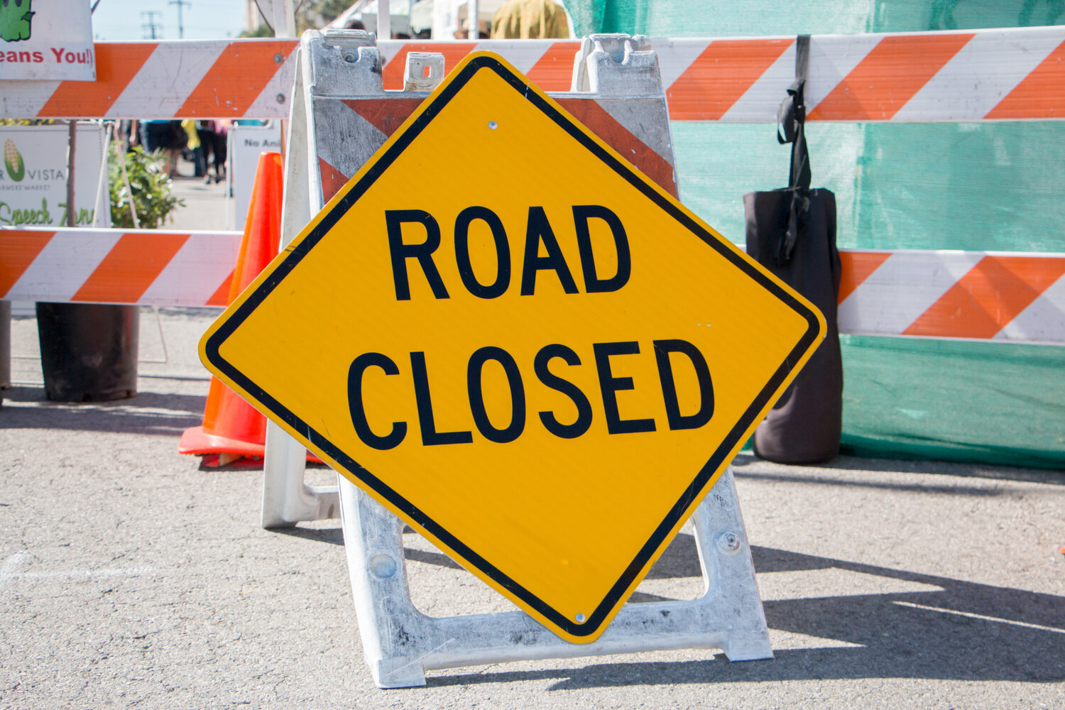 Road Closed Sign with Barricade in Background
