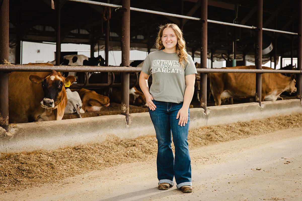 Breann Poole is pictured with cattle on Northwest's R.T Wright Farm. (Photo by Lilly Cook/Northwest Missouri State University)