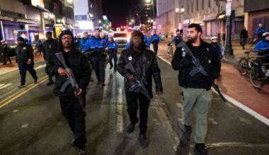 Armed members of the Black Panther Party for Self-Defense march down Market Street in Philadelphia with a crowd of protesters on Jan. 8 to rally against the killing of Renee Good who was shot by an ICE agent in Minneapolis, Minn.