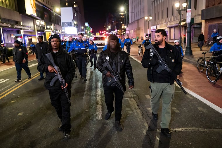 Armed members of the Black Panther Party for Self-Defense march down Market Street in Philadelphia with a crowd of protesters on Jan. 8 to rally against the killing of Renee Good who was shot by an ICE agent in Minneapolis, Minn.