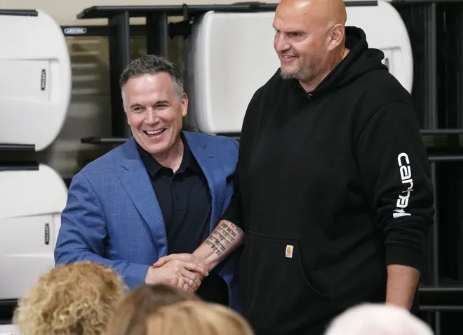 U.S. Senators from Pennsylvania Dave McCormick, left, and John Fetterman arrive for a roundtable discussion with community leaders dealing with housing, food insecurity and homelessness hosted at St. Paul's Neighborhood Center in Erie, Pa., on Aug. 28, 2026.