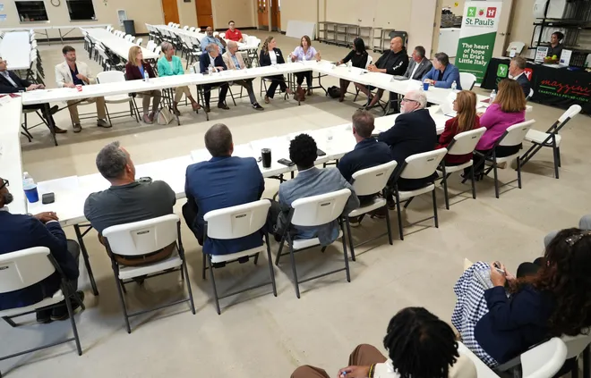 Community leaders join, at right, U.S. Senators John Fetterman, Dave McCormick and Erie Insurance CEO Tim NeCastro for a roundtable discussion dealing with housing, food insecurity and homelessness hosted at St. Paul's Neighborhood Center in Erie, Pa., on Aug. 28, 2026.