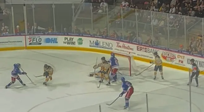 Kitchener Rangers forward Tanner Lam (far left) shoots the puck through a crowd and past obscured Erie Otters goaltender David Egorov during overtime of Saturday's Ontario Hockey League game at Erie Insurance Arena. Lam's goal capped Kitchener's 4-3 comeback victory in the Otters' home opener.