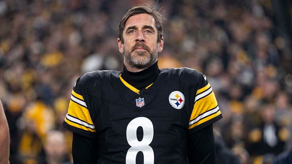 Aaron Rodgers standing on the sideline before an NFL game kicks off