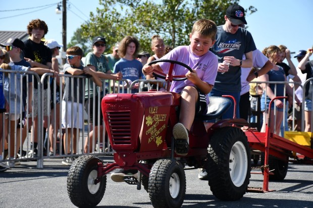 Brayden Zeltner participates in the children's pedal tractor pulling contest. (Courtesy of the Oley Valley Community Fair)