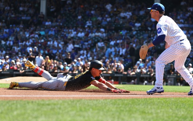 Cubs third baseman Alex Bregman waits for a late throw as Pirates shortstop Konnor Griffin slides in safely at third for a triple in the first inning Sept. 11, 2026, at Wrigley Field. (Chris Sweda/Chicago Tribune)
