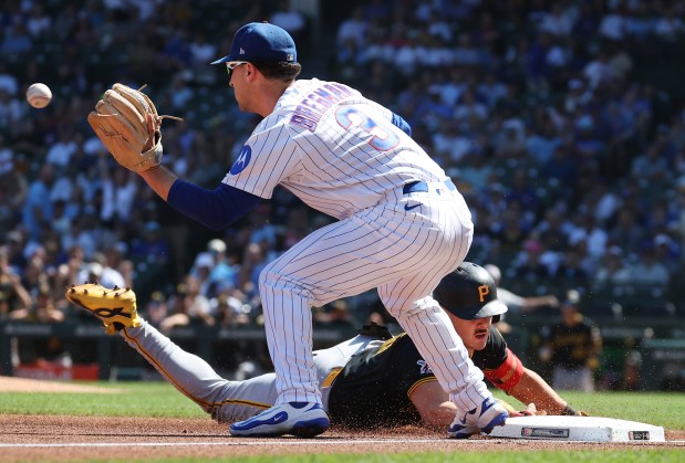 Cubs third baseman Alex Bregman catches a late throw as Pirates shortstop Konnor Griffin slides in safely for a triple in the first inning Sept. 11, 2026, at Wrigley Field. (Chris Sweda/Chicago Tribune)