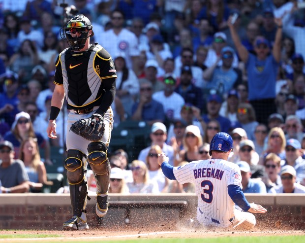 Cubs third baseman Alex Bregman slides in safely into home on a Michael Conforto sacrifice fly in the second inning against the Pirates on Sept. 11, 2026, at Wrigley Field. (Chris Sweda/Chicago Tribune)