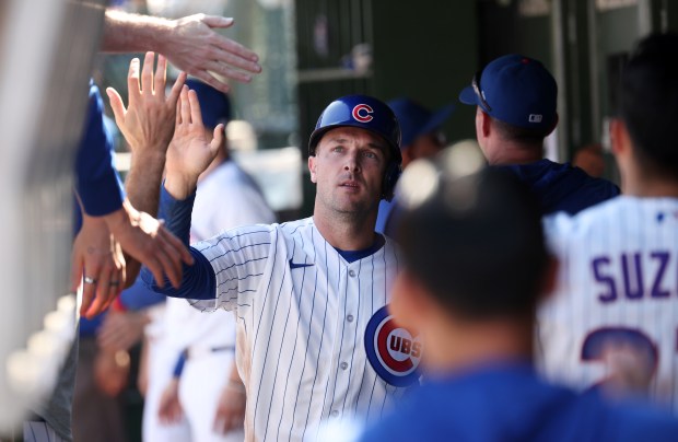 Cubs third baseman Alex Bregman high-fives teammates in the dugout after scoring on a Michael Conforto sacrifice fly in the second inning against the Pirates on Sept. 11, 2026, at Wrigley Field. (Chris Sweda/Chicago Tribune)