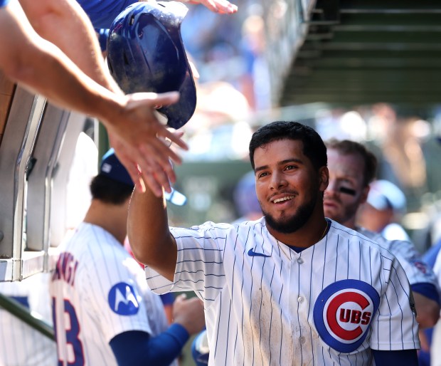Cubs second baseman Pedro Ramírez high-fives teammates in the dugout after scoring in the second inning against the Pirates on Sept. 11, 2026, at Wrigley Field. (Chris Sweda/Chicago Tribune)