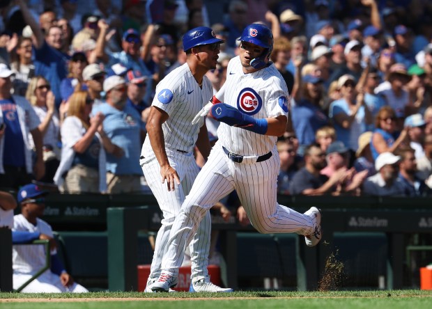Cubs right fielder Seiya Suzuki sprints around third base on his way to scoring on a Michael Busch double and a Pirates error in the third inning Friday, Sept. 11, 2026, at Wrigley Field. (Chris Sweda/Chicago Tribune)
