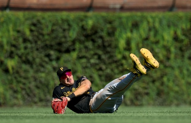 Pirates shortstop Konnor Griffin falls to the grass after catching a ball that went for a sacrifice fly for Cubs first baseman Michael Busch in the fourth inning Sept. 11, 2026, at Wrigley Field. (Chris Sweda/Chicago Tribune)