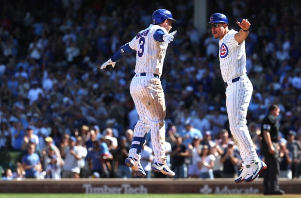 Cubs third baseman Alex Bregman, left, celebrates with third-base coach Quintin Berry after hitting a two-run home run in the fourth inning against the Pirates on Sept. 11, 2026, at Wrigley Field. (Chris Sweda/Chicago Tribune)