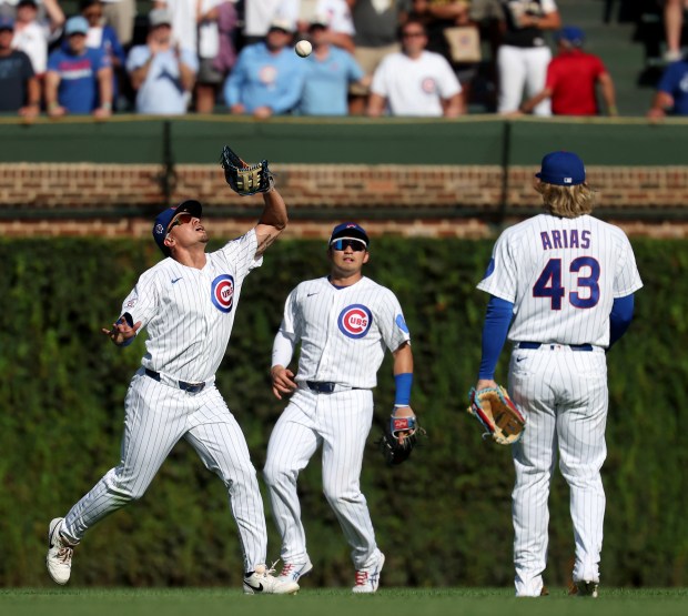 Center fielder Tyrone Taylor, left, catches a fly ball for the final out of the Cubs' 12-2 victory over the Pirates on Friday, Sept. 11, 2026, at Wrigley Field. (Chris Sweda/Chicago Tribune)