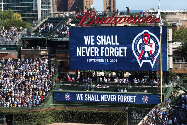 On the 25th anniversary of the September 11, 2001 terrorist attacks on the U.S., a moment of silence is held at Wrigley Field in Chicago before a game between the Chicago Cubs and the Pittsburgh Pirates. (Chris Sweda/Chicago Tribune)
