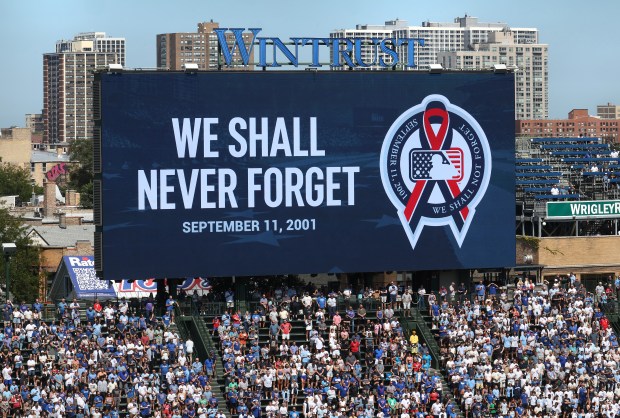 On the 25th anniversary of the September 11, 2001 terrorist attacks on the U.S., a moment of silence is held at Wrigley Field in Chicago before a game between the Chicago Cubs and the Pittsburgh Pirates. (Chris Sweda/Chicago Tribune)