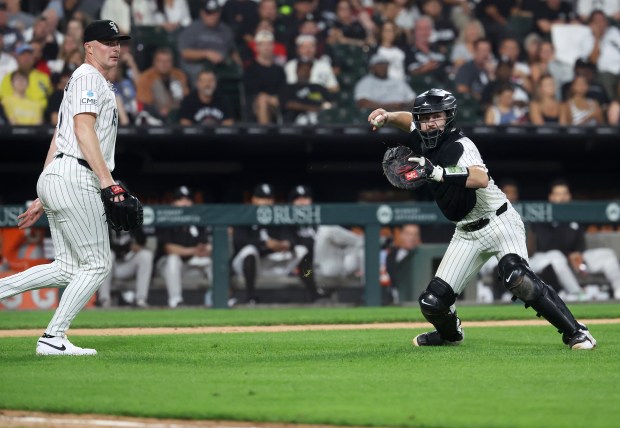 Chicago White Sox relief pitcher Sean Newcomb (left) looks on as catcher Kyle Teel prepares to throw to first base on a bunt single for Pittsburgh Pirates first baseman Spencer Horwitz in the seventh inning of a game at Rate Field in Chicago on Sept. 9, 2026. (Chris Sweda/Chicago Tribune)