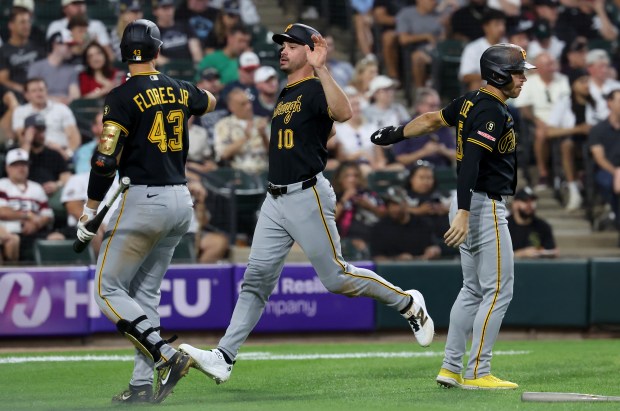 Pittsburgh Pirates designated hitter Bryan Reynolds (10) is congratulated by teammates Rafael Flores Jr. (43) and Brandon Lowe (right) after Reynolds scored on a two-run single by Spencer Horwitz in the second inning of a game against the Chicago White Sox at Rate Field in Chicago on Sept. 8, 2026. (Chris Sweda/Chicago Tribune)