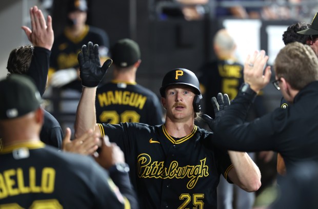 Pittsburgh Pirates center fielder Billy Cook (25) is congratulated by his teammates in the dugout after scoring on a single by Rafael Flores Jr. in the seventh inning of a game against the Chicago White Sox at Rate Field in Chicago on Sept. 9, 2026. (Chris Sweda/Chicago Tribune)