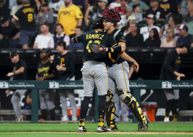Pittsburgh Pirates relief pitcher Yohan Ramírez (49) and catcher Rafael Flores Jr. celebrate after closing out the Chicago White Sox in the seventh inning of a game at Rate Field in Chicago on Sept. 9, 2026. (Chris Sweda/Chicago Tribune)
