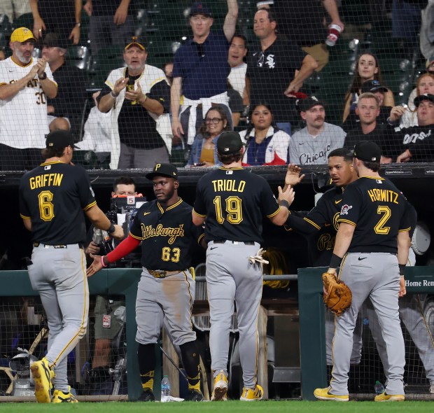 Pittsburgh Pirates third baseman Jared Triolo (19) is congratulated by his teammates after making a double play to end the bottom of the eighth inning against the Chicago White Sox at Rate Field in Chicago on Sept. 9, 2026. (Chris Sweda/Chicago Tribune)