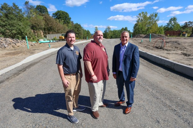Pittston Twp. Manager Kyle Rozitski, left, Pittston Twp. Supervisor Joseph Hawk, and Pittston Mayor Michael Lombardo, in front of underdeveloped land in the Stauffer Point development that will be part of Pittston City, on Friday, Sept. 18, 2026. (JASON ARDAN / STAFF PHOTOGRAPHER)