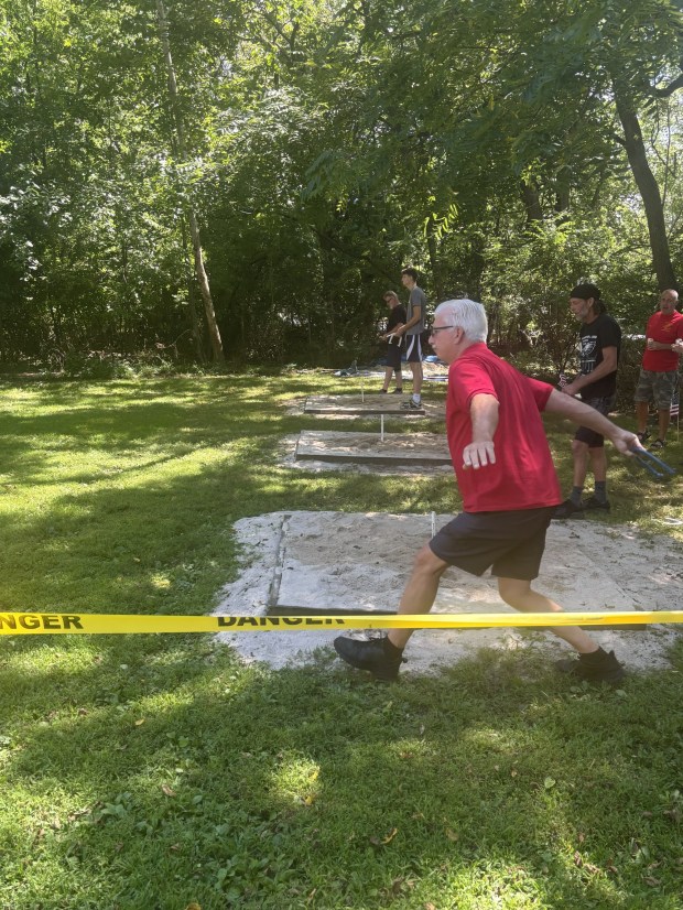 Upper Darby Detachment member Mark Reeves winds up for his toss at the Sands of Secane horseshoe tournament. (COURTESY OF PETE LEAHY)