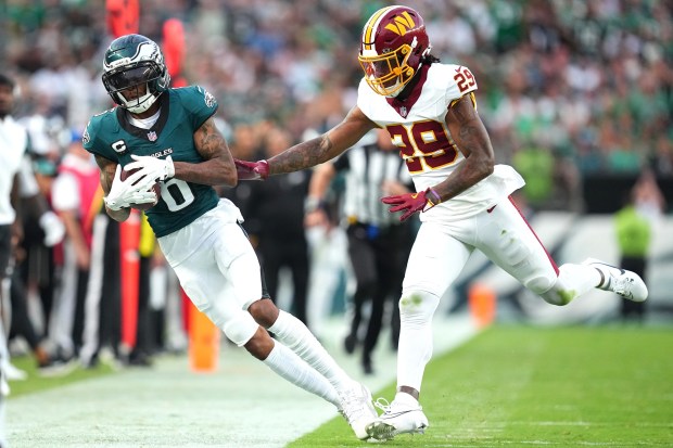 Wide receiver DeVonta Smith (6) of the Philadelphia Eagles catches a pass near the sideline against Darius Rush (29) of the Washington Commanders in the third quarter at Lincoln Financial Field on Sunday, Sept. 13, 2026. (Mitchell Leff/Getty Images)